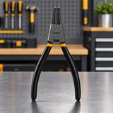 Straight-tip Coofix circlip pliers on a workshop table