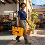 Technician carrying the Ingco toolbox outside a workshop