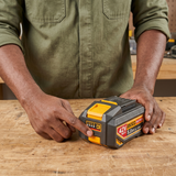 Technician checking the Ingco 5.0Ah battery at a workbench