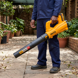 Technician clearing dry leaves with the Ingco cordless air blower