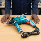 Technician inspecting the Total TG1091366 impact drill