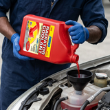 Technician pouring ABRO Red Radiator Coolant into a coolant reservoir through a funnel