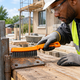 Technician using the Coofix wire brush on rusty steel