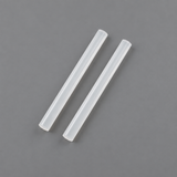 Two Coofix glue sticks on grey