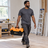 Worker carrying the Coofix toolbox by its handle